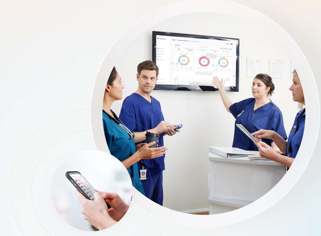 Nurses pointing to analytics and reporting dashboard