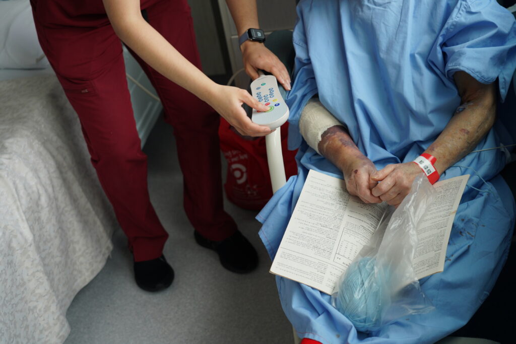 Nurse showing patient the nurse call handset