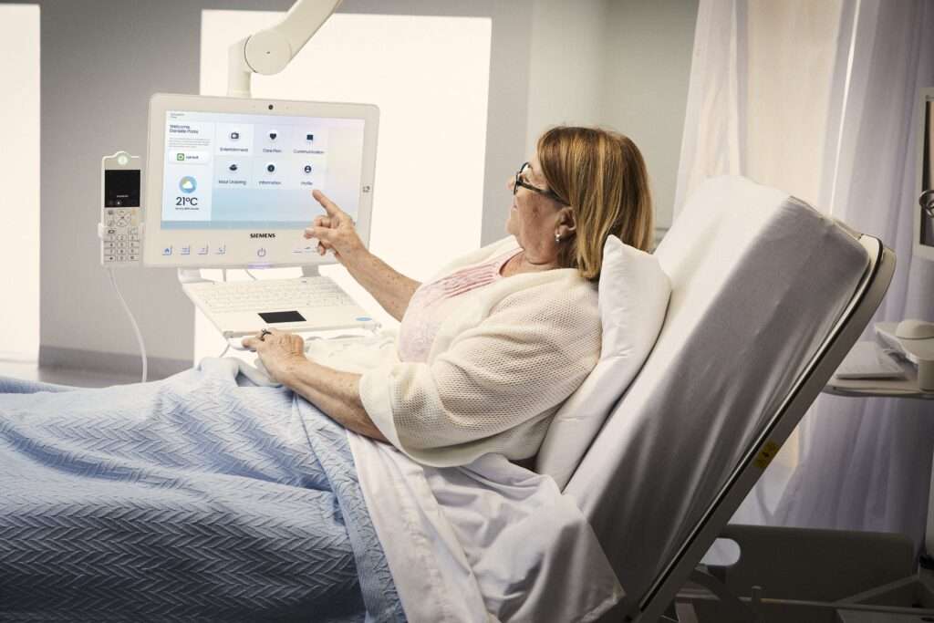 Patient in hospital bed using concierge himed patient engagement and entertainment solution